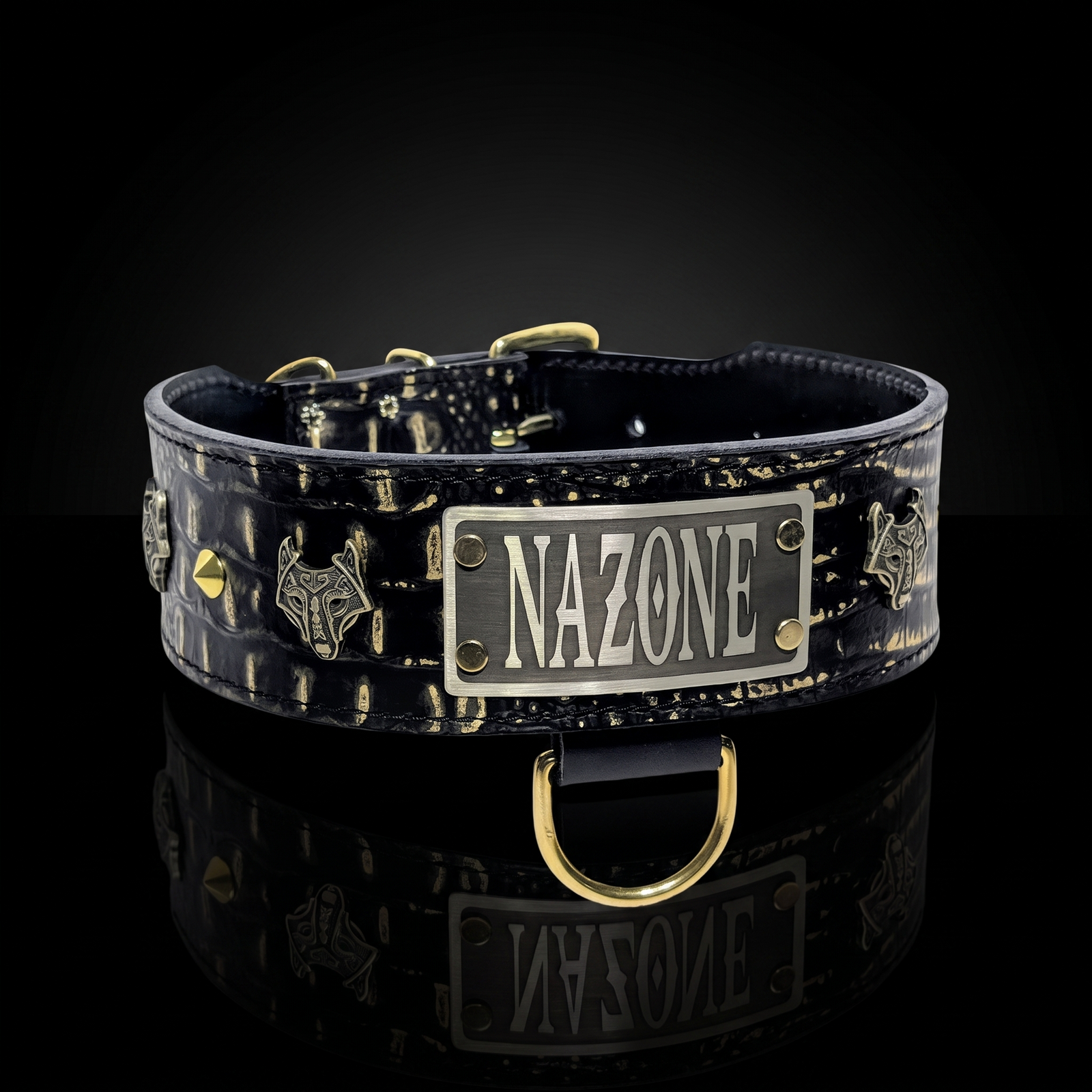A black and gold patterned leather dog collar with a silver metal plate engraved with 'NAZONE' and gold-tone hardware, shown on a reflective black background.