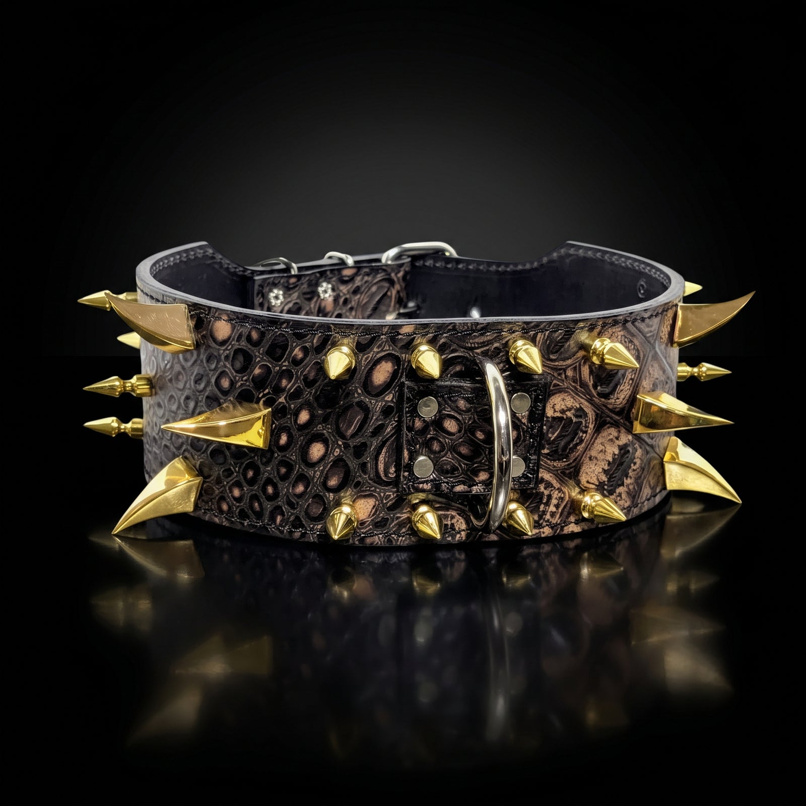 A black crocodile-embossed leather collar decorated with sharp gold-toned spikes and a silver metal buckle, displayed on a reflective black surface.