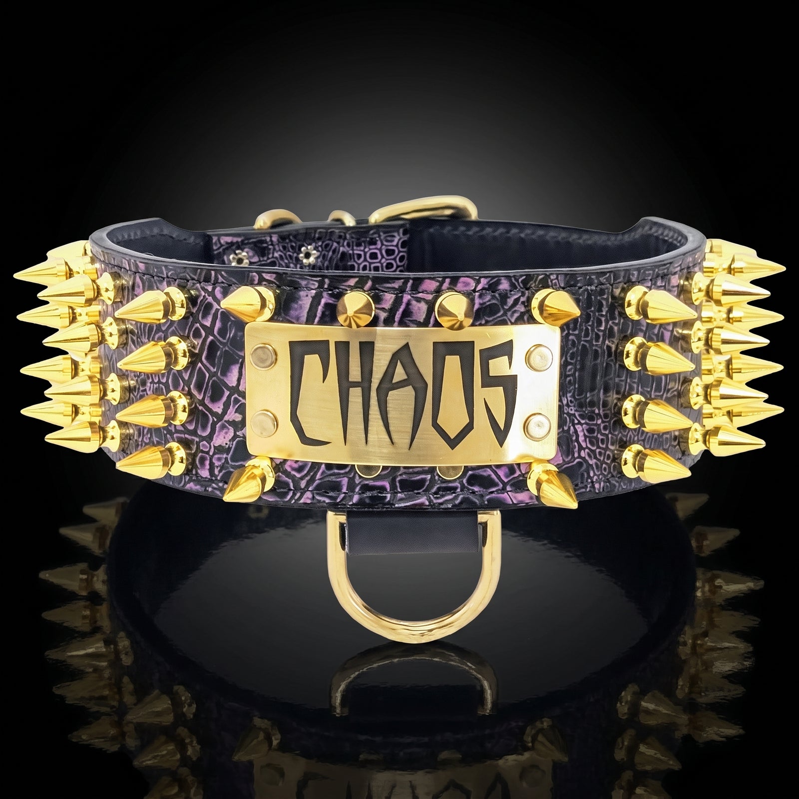 A purple and black textured leather collar with gold-tone spikes on both sides and a central gold plate engraved with the word 'CHAOS'.