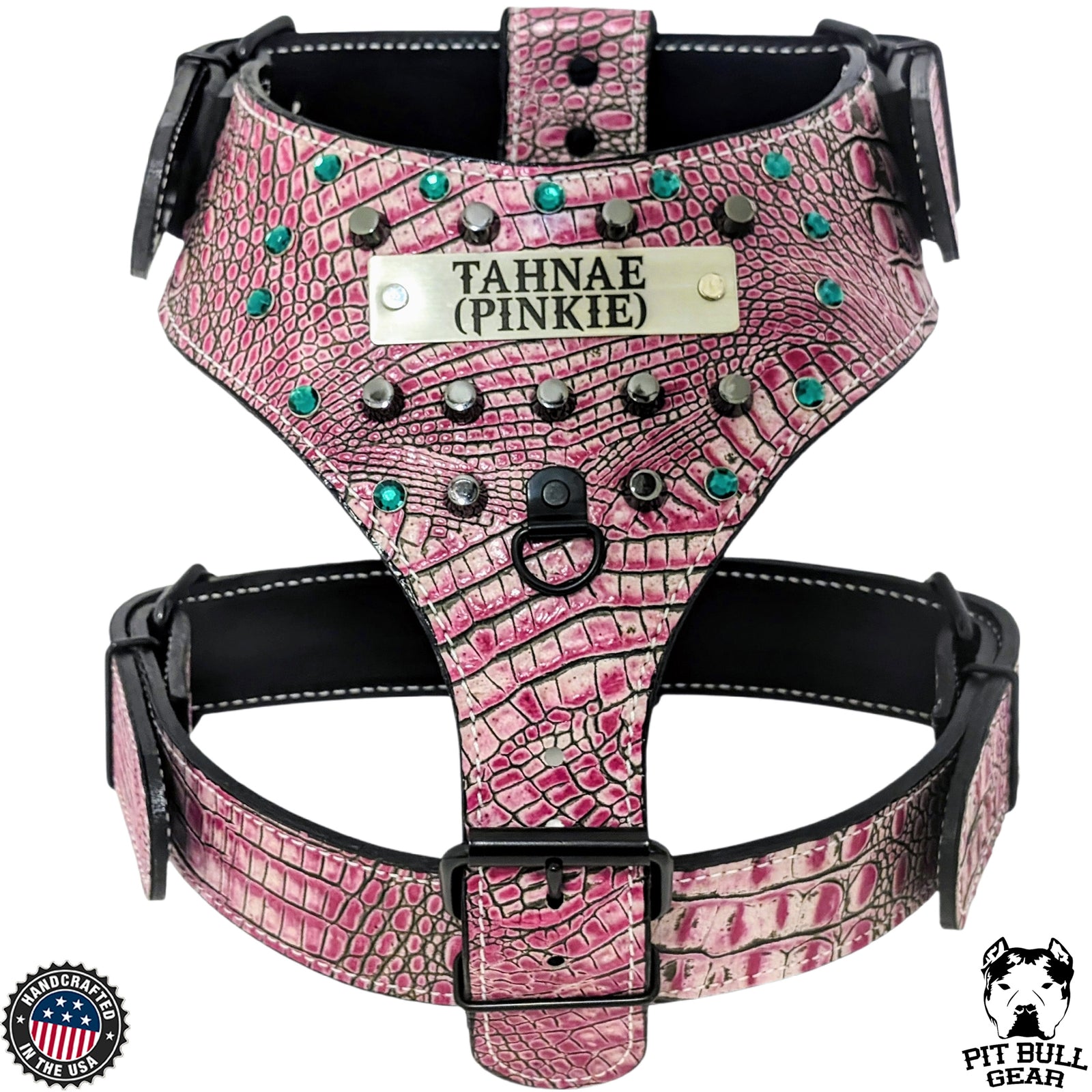 Pink dog harness with decorative studs and a label on a white background
