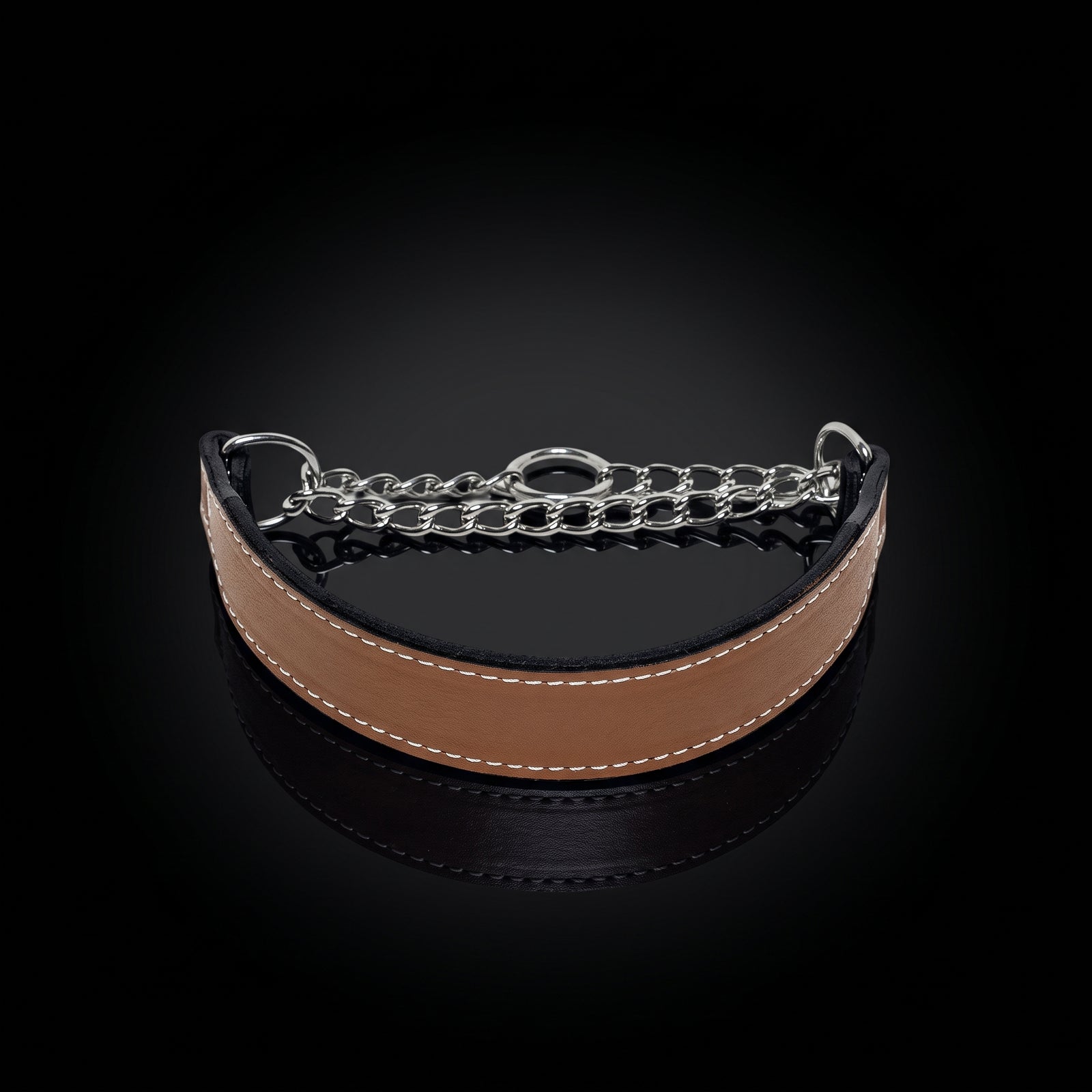 A curved tan leather collar with white stitching and a silver-tone metal chain link closure, displayed on a reflective black background.