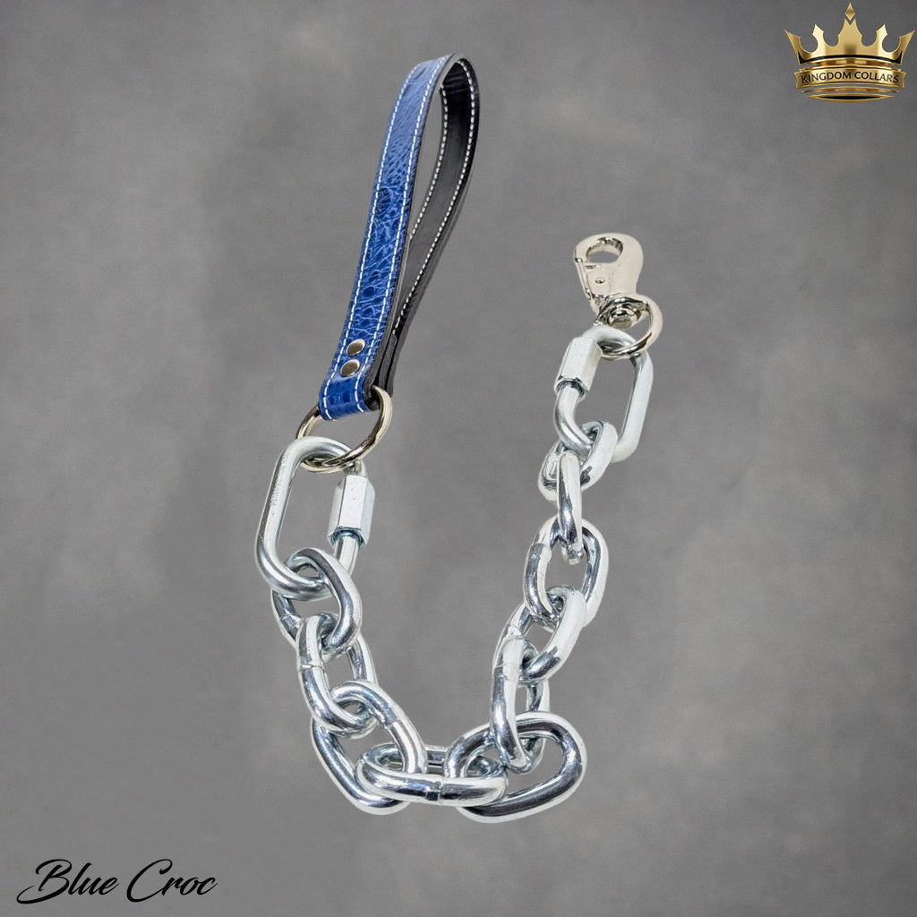 Chain dog leash with blue croc leather strap on a gray background.