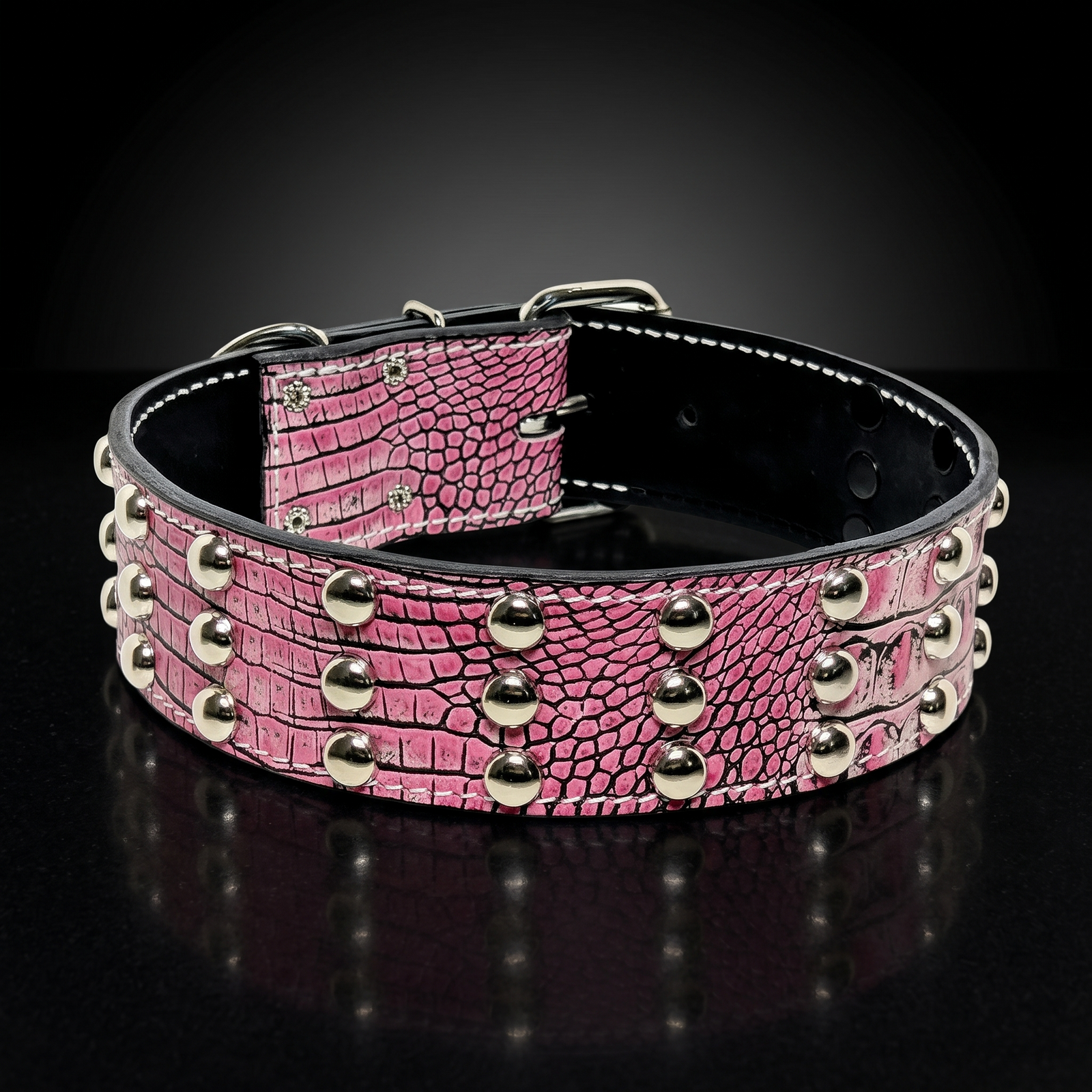 Pink crocodile-embossed leather dog collar with three rows of polished silver dome studs and chrome hardware, displayed on a white background.