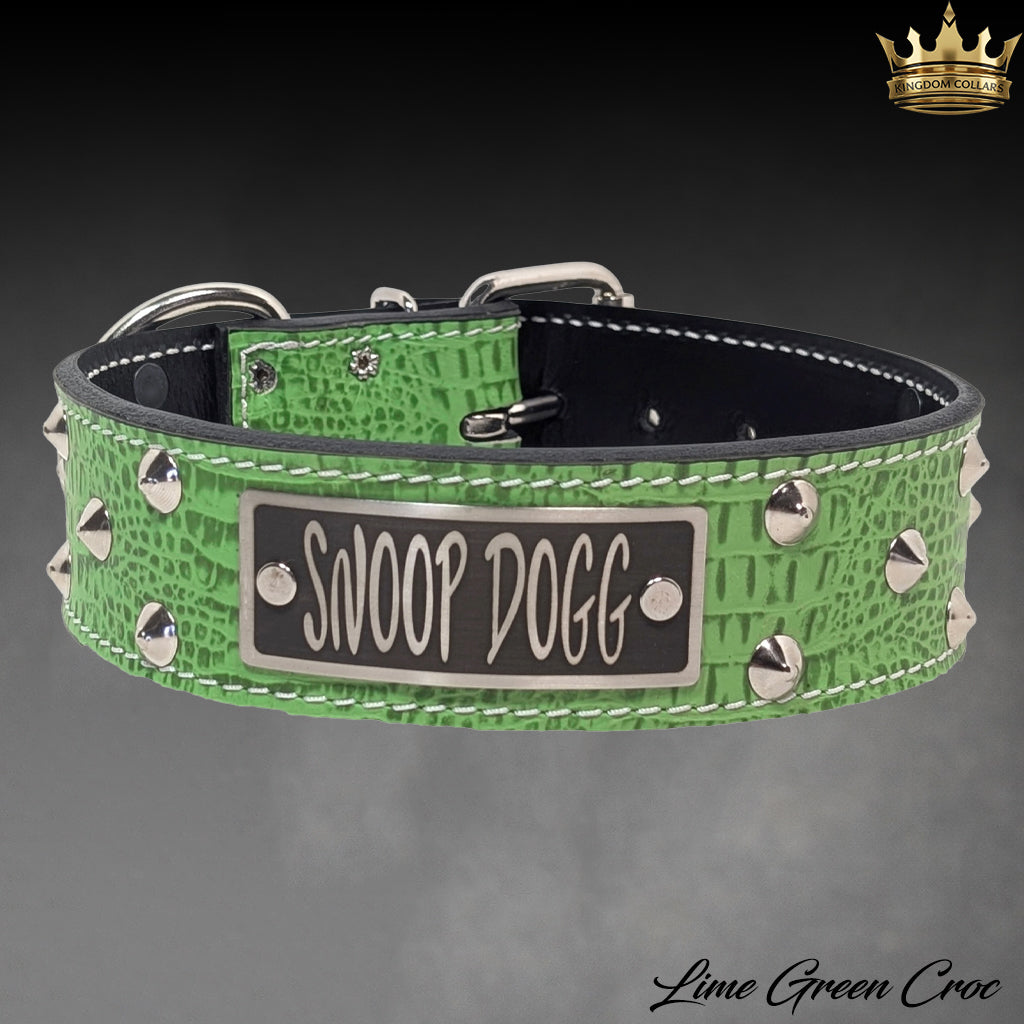 A custom dog collar made of lime green crocodile-embossed leather with silver studs and a central black nameplate reading 'SNOOP DOG'.