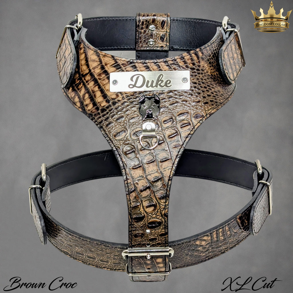 Brown crocodile pattern dog harness with 'Duke' branding on a gray background