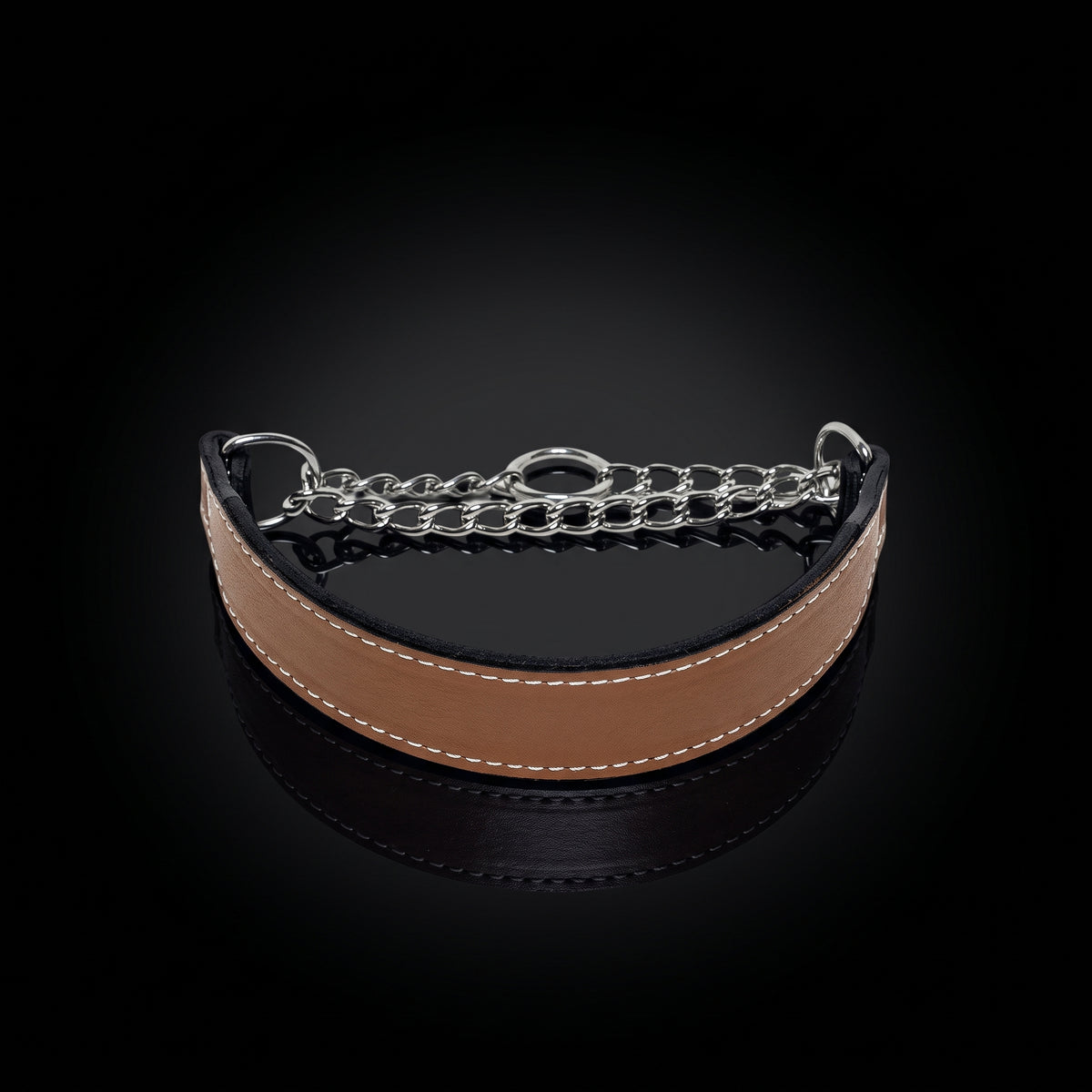 A curved tan leather collar with white stitching and a silver-tone metal chain link closure, displayed on a reflective black background.