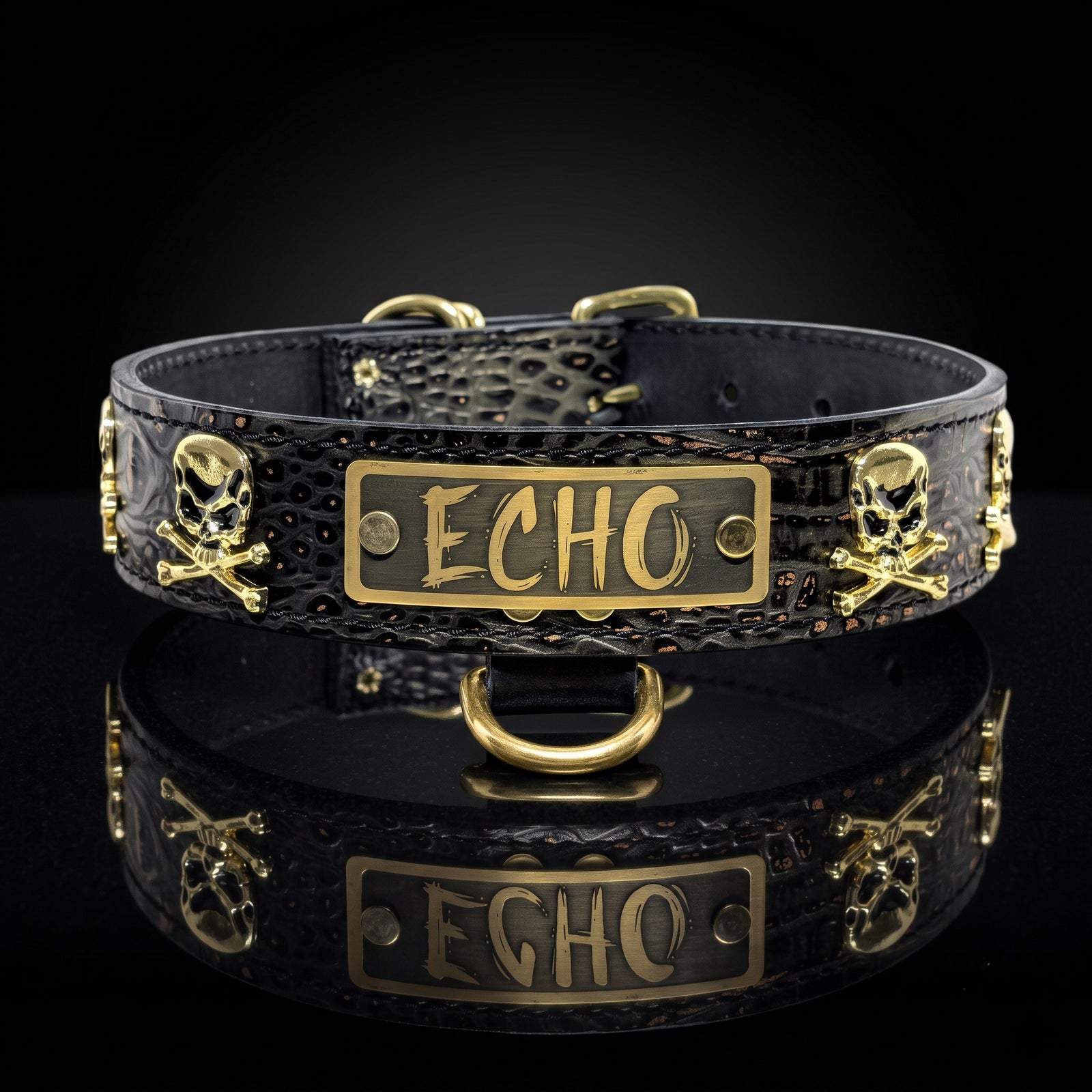 A black crocodile-embossed collar with gold-tone hardware, featuring skull and crossbones motifs and a central rectangular plate engraved with the name 'ECHO'. The collar is displayed on a reflective black surface against a dark background.